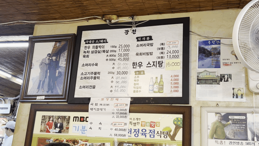 광천식당 벽에 걸린 메뉴판. 소머리수육, 소머리국밥 등 주요 메뉴와 가격이 적혀있다. The wall-mounted menu at Gwangcheon Sikdang listing various Korean beef dishes like Someori-suyuk and their prices in KRW.