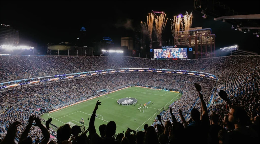 MLS 홈경기에서 가득 찬 경기장과 팬들의 열광적인 응원 분위기 Packed MLS stadium showing fan experience and match atmosphere at night